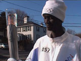 Francis Bok carries the Olympic torch